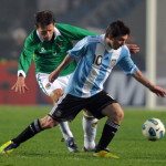 Argentine forward Lionel Messi (R) vies